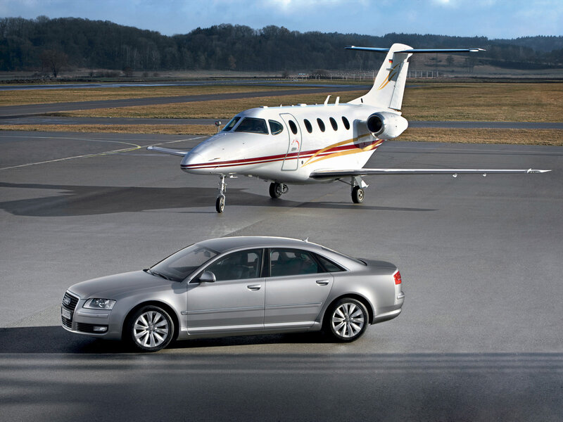 Audi and private jet on tarmac