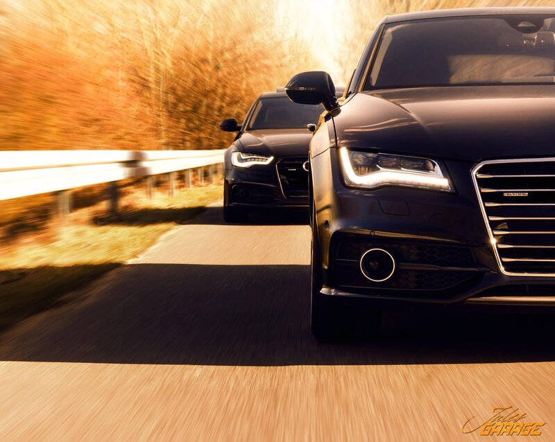 Audi cars on a road at sunset