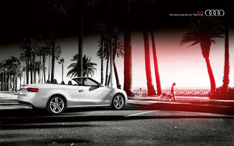 Audi convertible on a palm-lined street