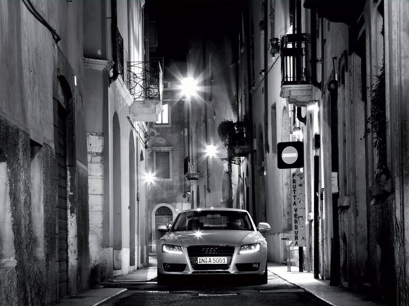Audi in a narrow alley at night