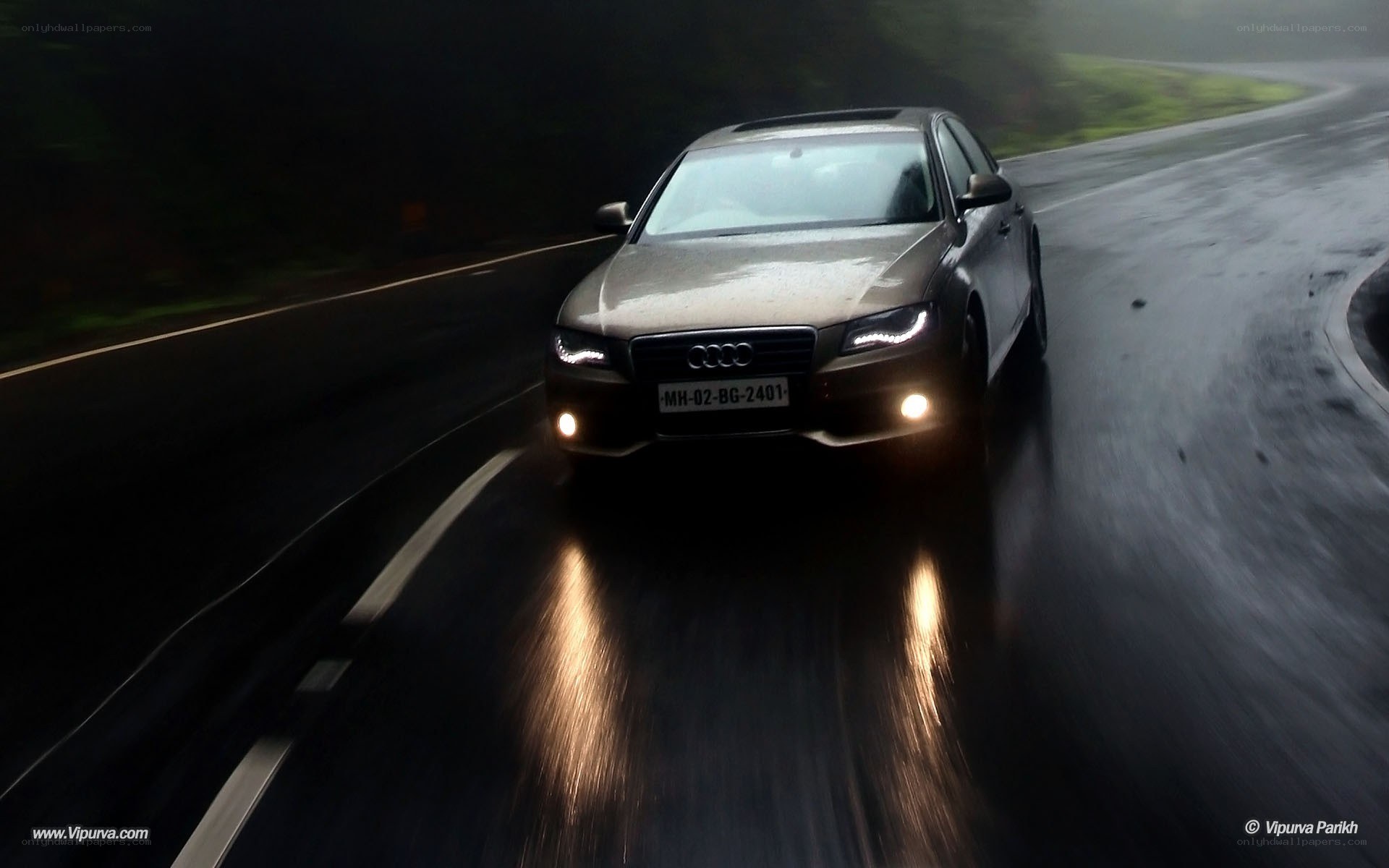 Audi on a wet road at night