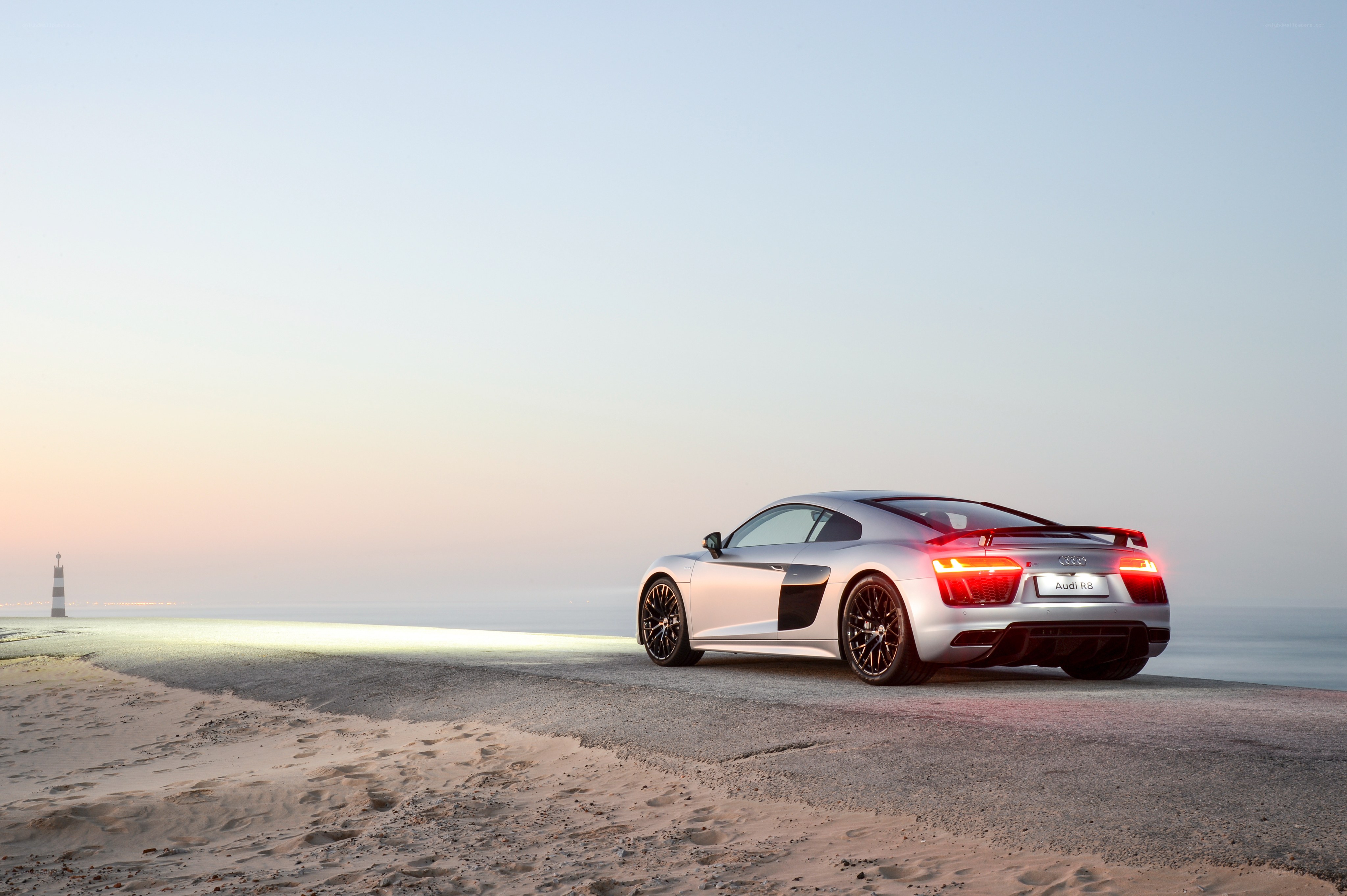 Audi R8 on a beach at sunset
