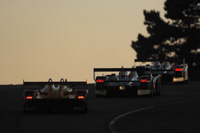 Audi race cars at dusk