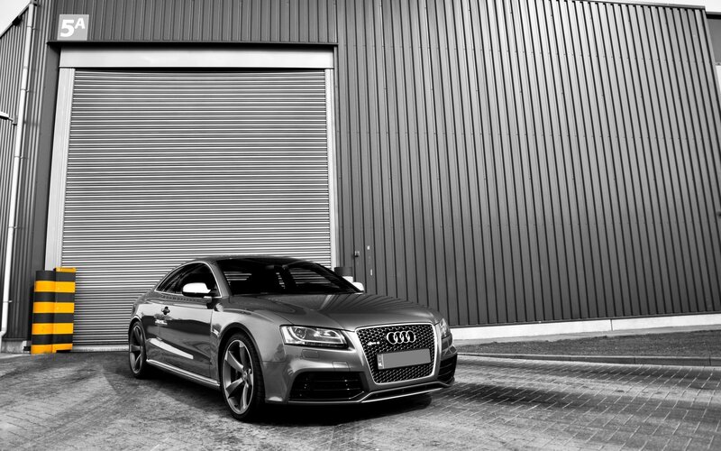 Audi RS5 in front of a warehouse