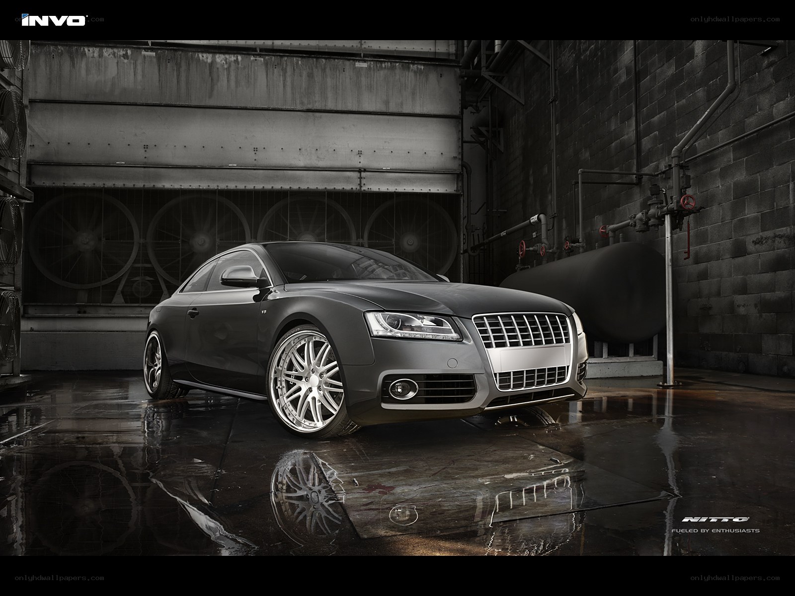 Audi with custom wheels in a warehouse