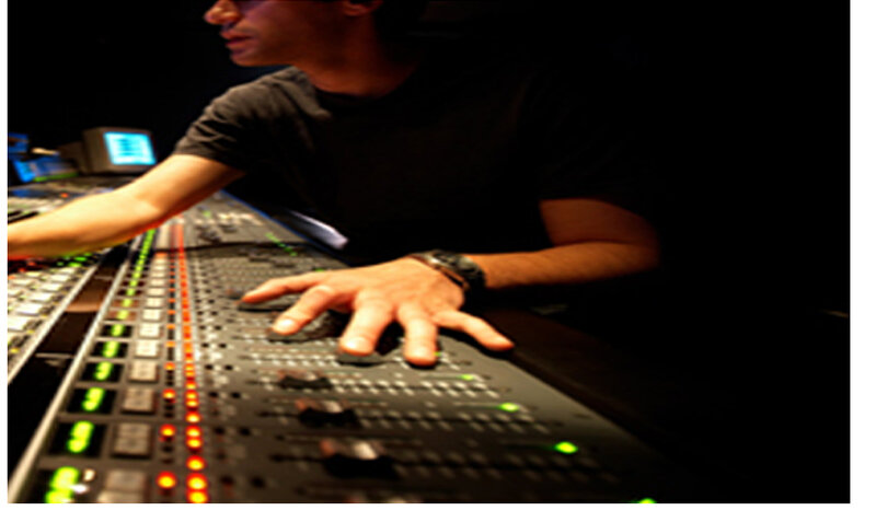 audio engineer at mixing console