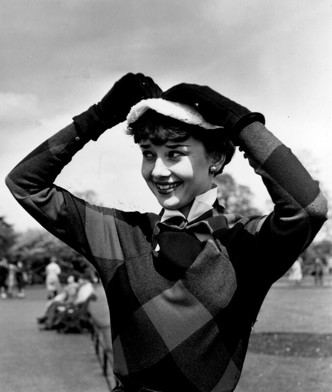 Audrey Hepburn adjusting hat
