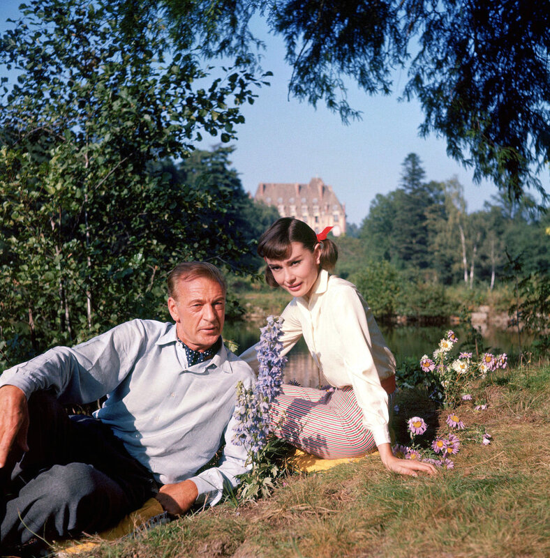 Audrey Hepburn and William Holden in a park
