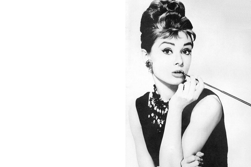 Audrey Hepburn applying lipstick