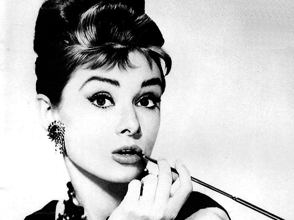 Audrey Hepburn applying lipstick