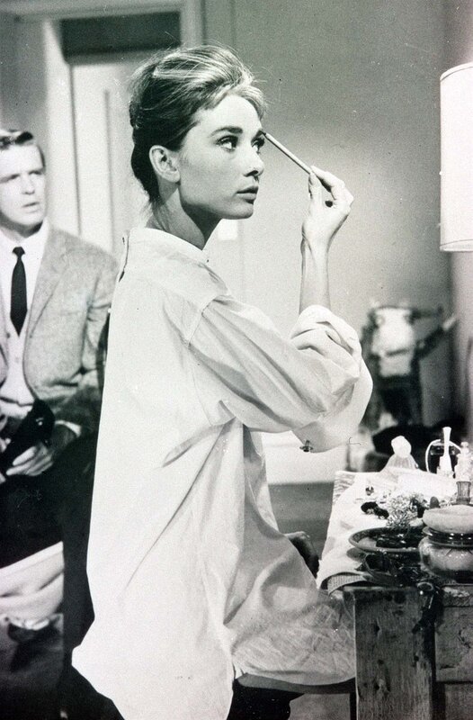 Audrey Hepburn applying makeup