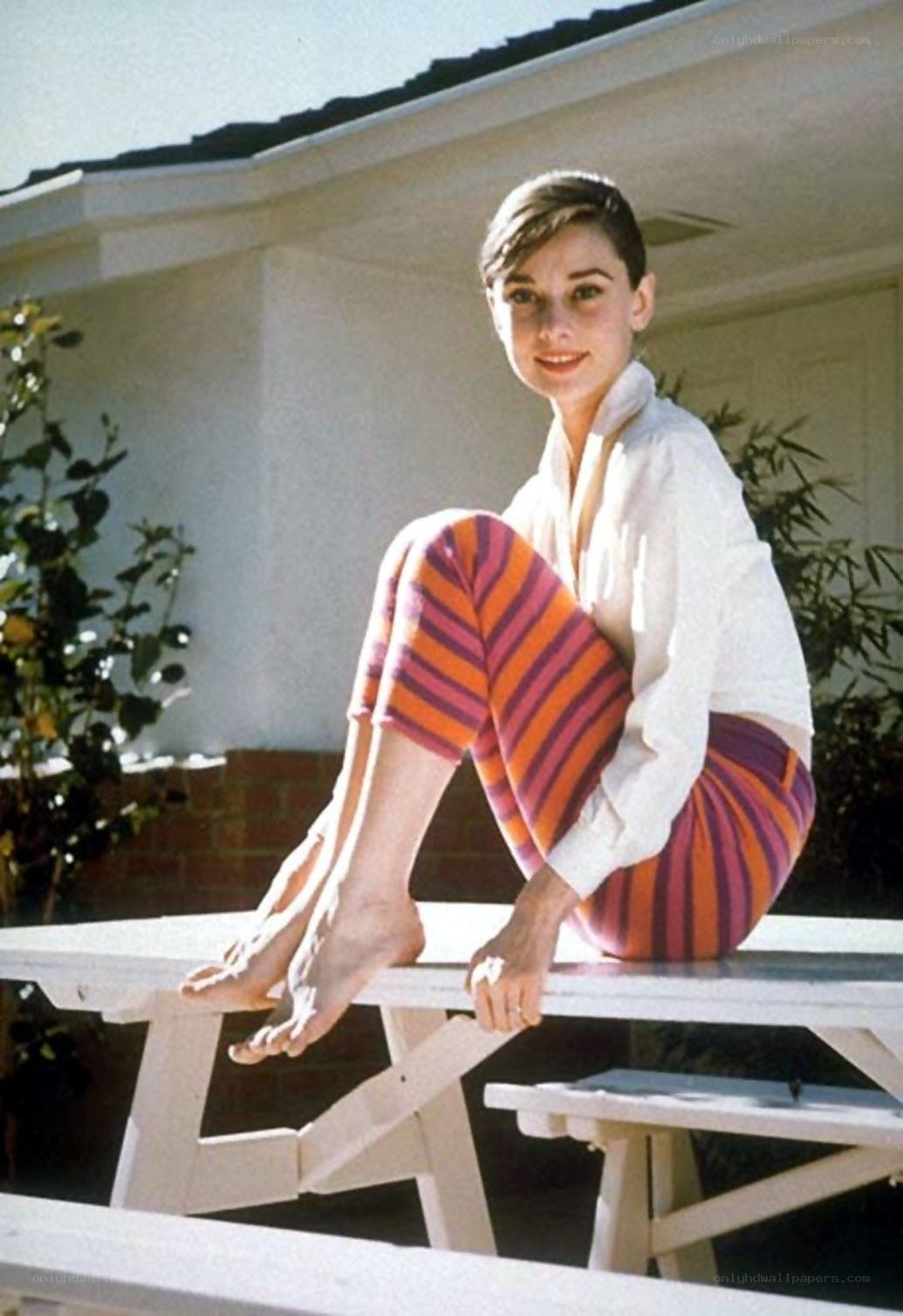 Audrey Hepburn on a picnic table