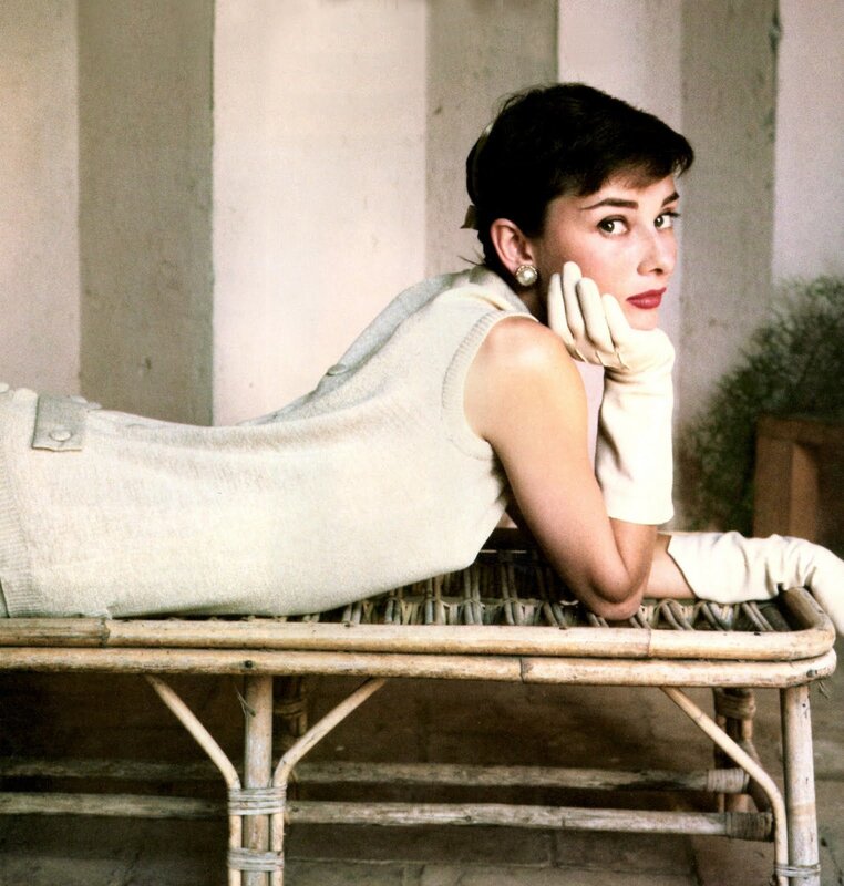 Audrey Hepburn on a wicker bench