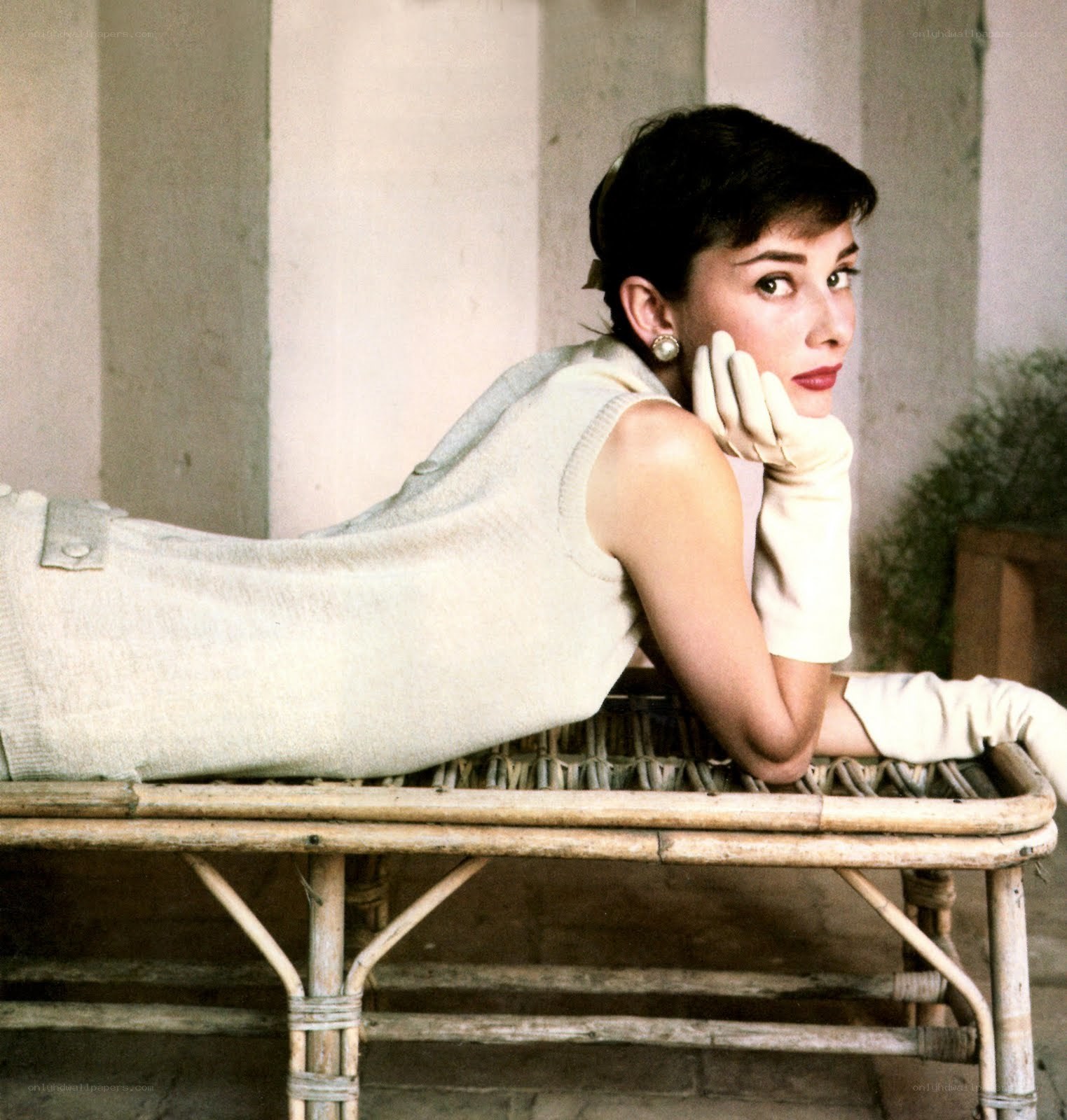 Audrey Hepburn on a wicker bench