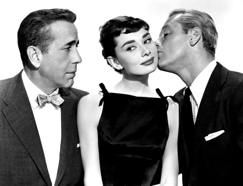 Audrey Hepburn with two men