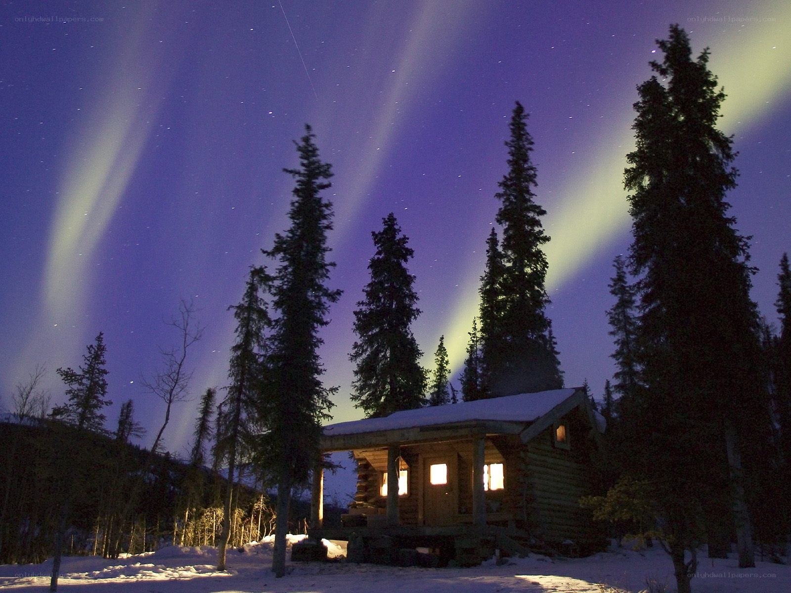 Aurora borealis over a cabin