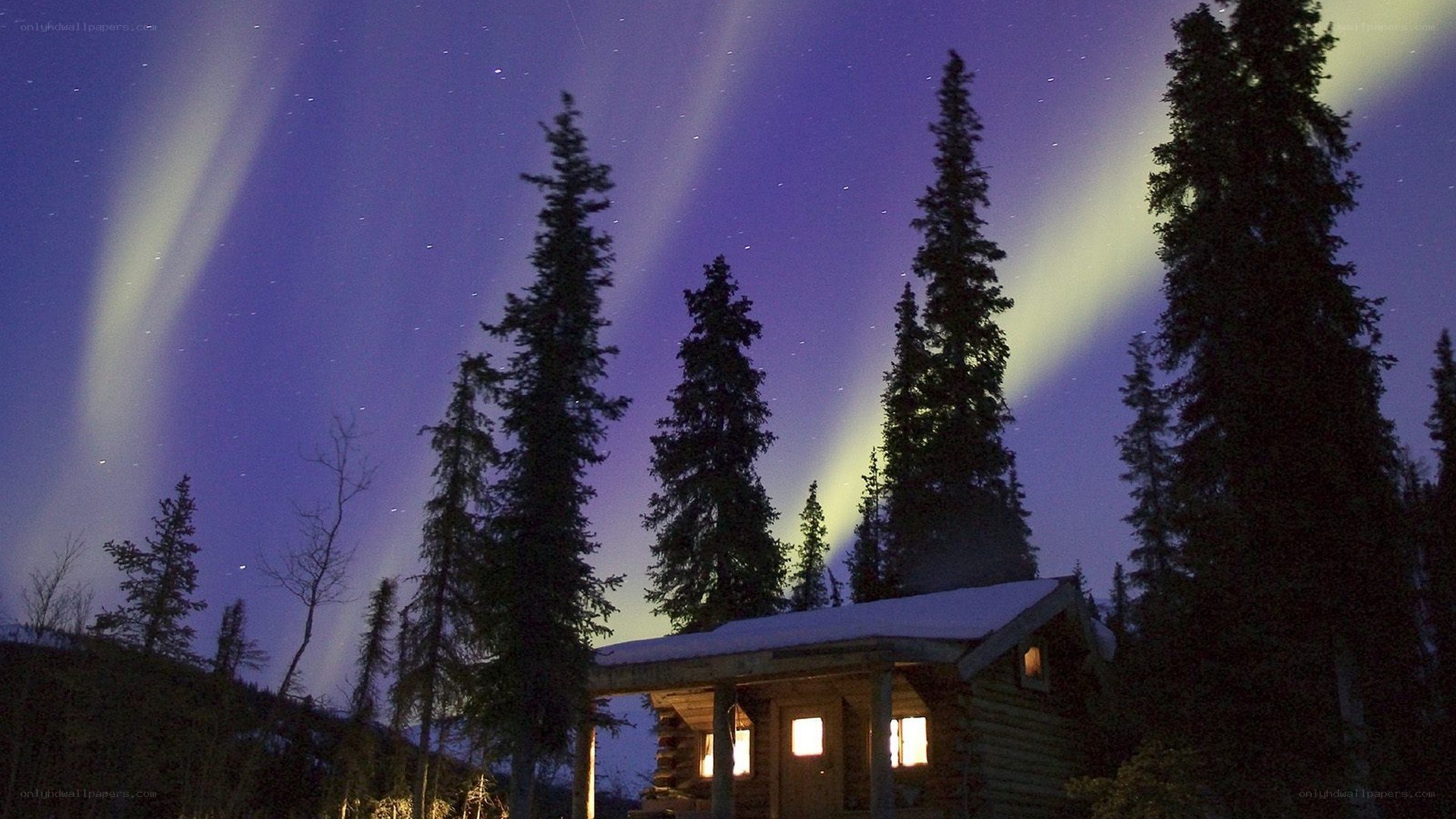Aurora borealis over a cabin
