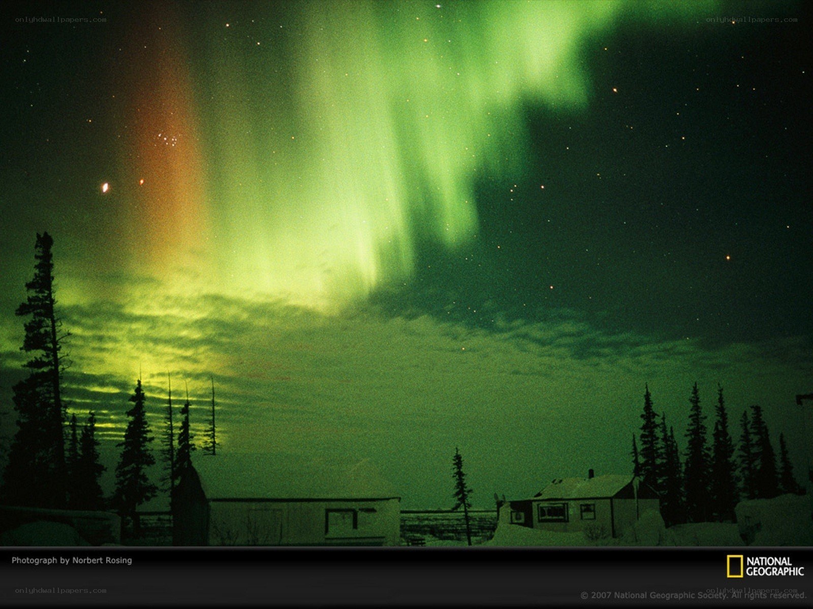 Aurora borealis over a cabin