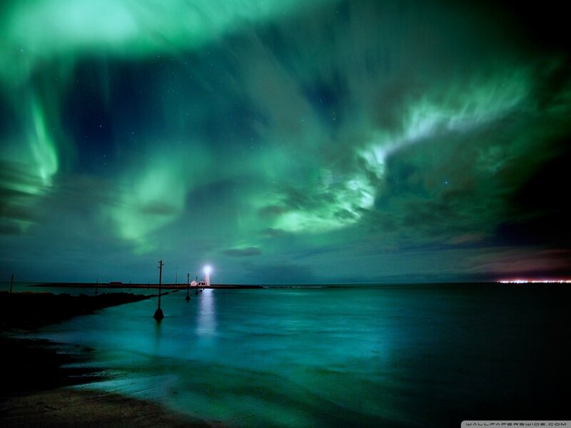 Aurora borealis over a lighthouse
