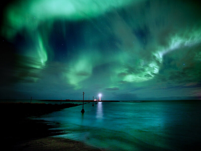 Aurora borealis over a lighthouse