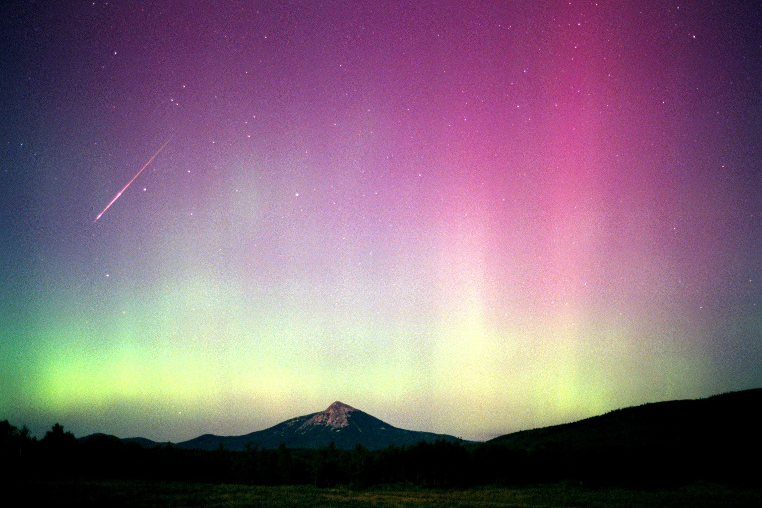 Aurora borealis over a mountain