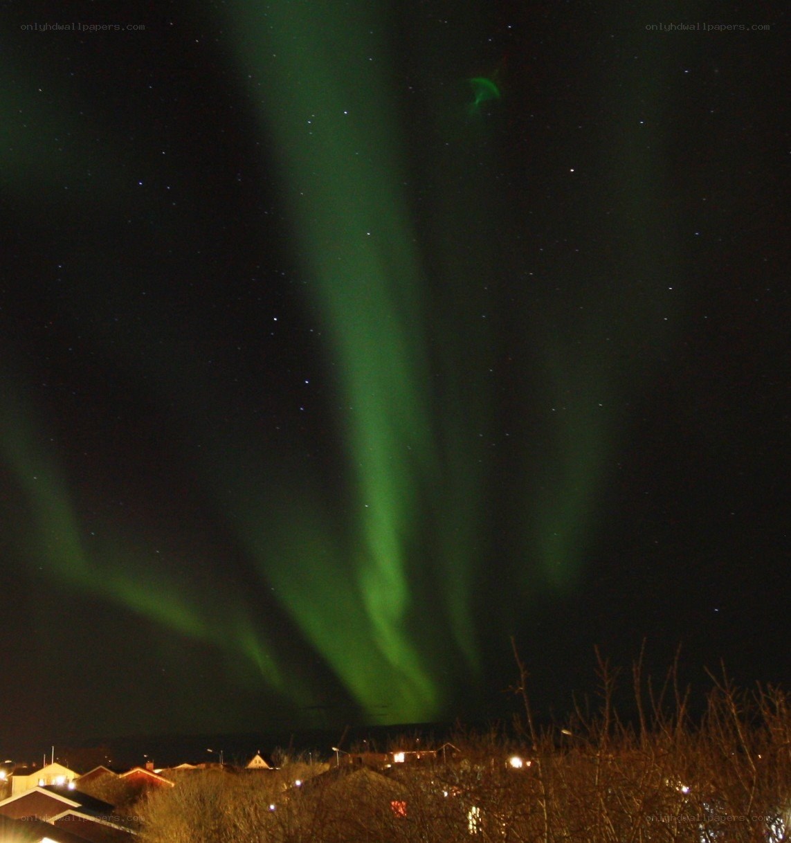 Aurora borealis over a town
