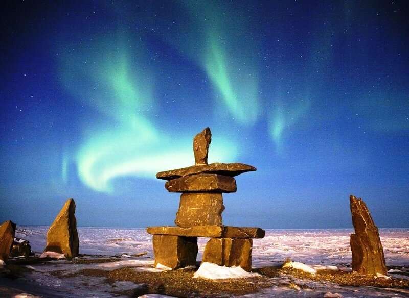 Aurora borealis over an inukshuk