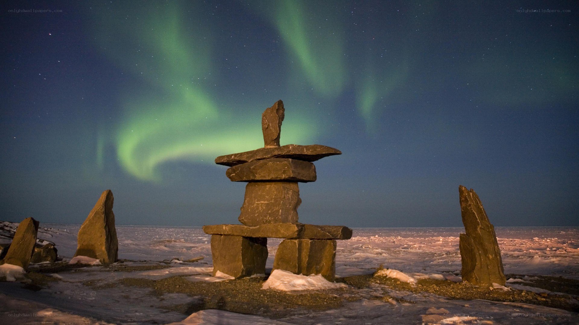Aurora borealis over an inukshuk