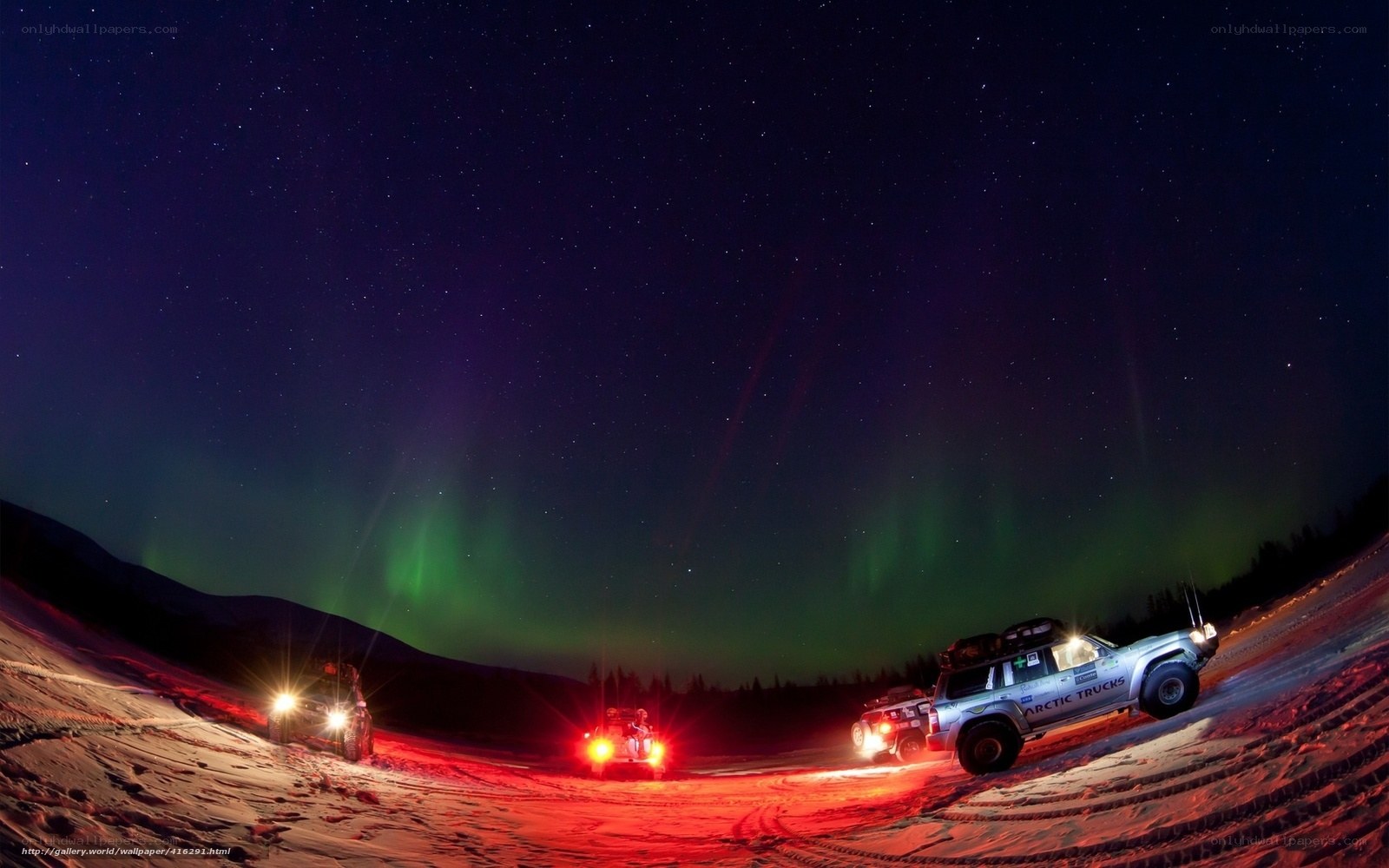 Aurora borealis over Arctic trucks