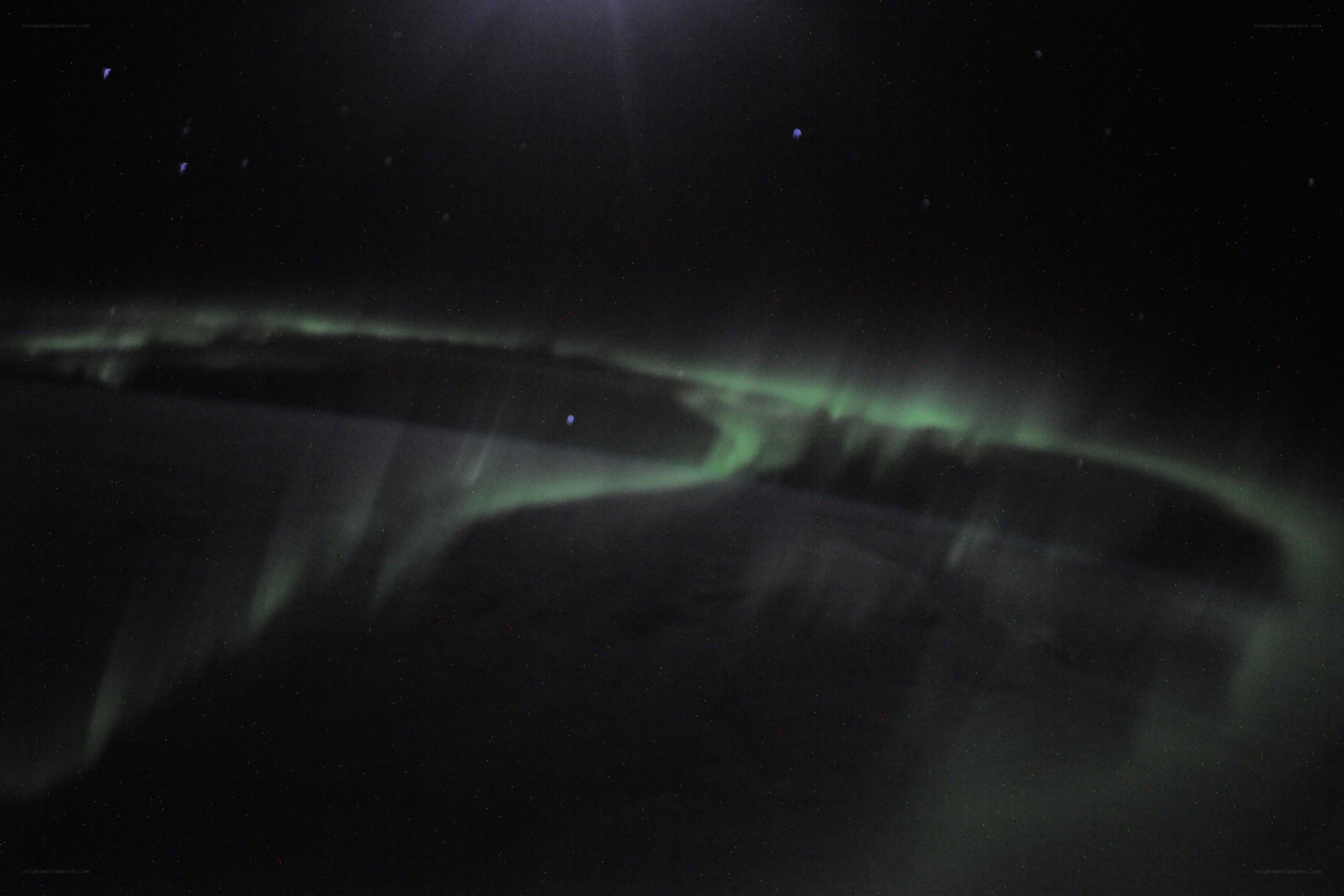 Aurora borealis over dark landscape