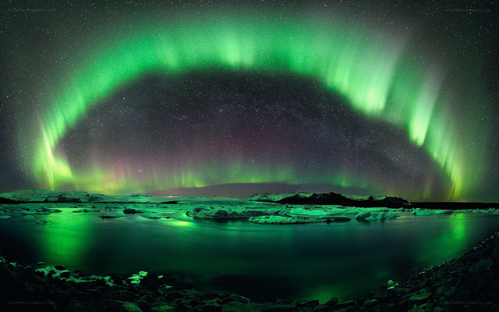 Aurora borealis over icy landscape