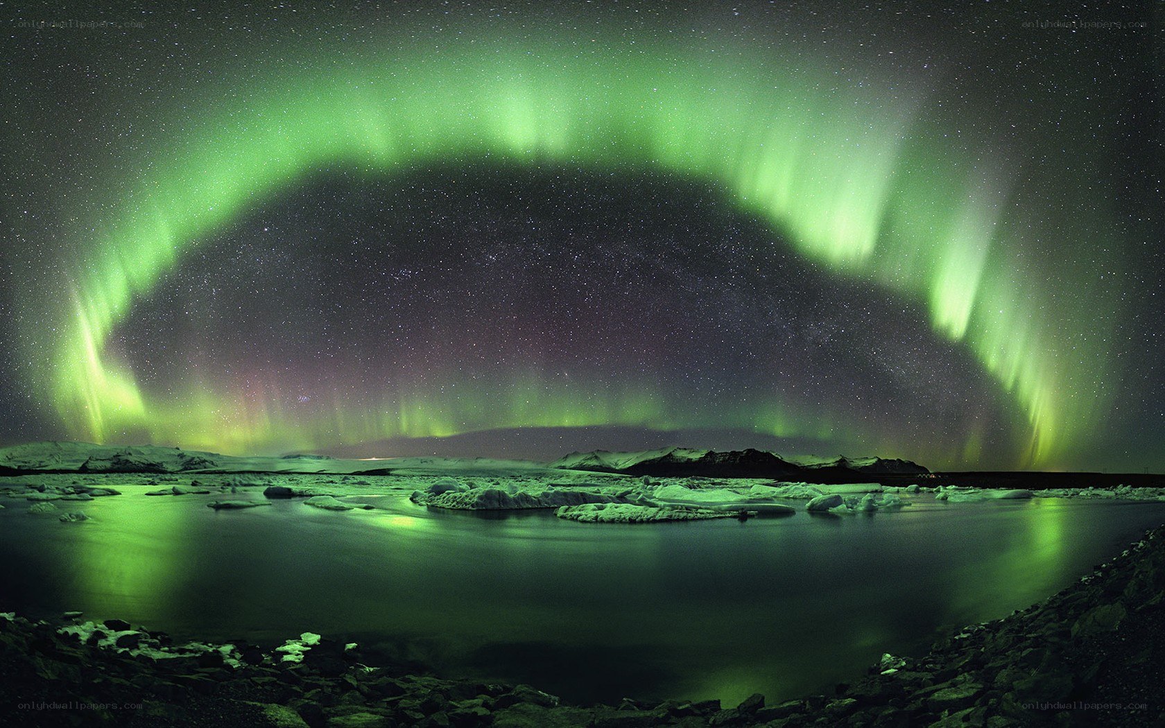Aurora borealis over icy landscape