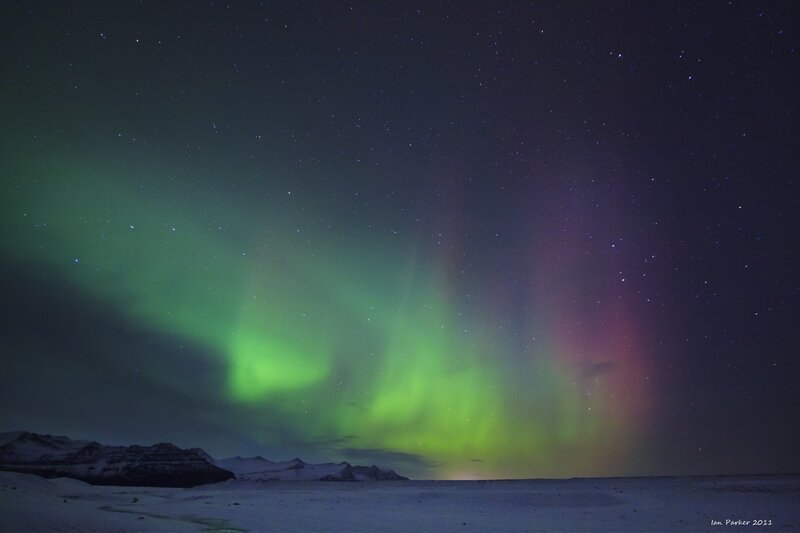 Aurora borealis over snowy landscape