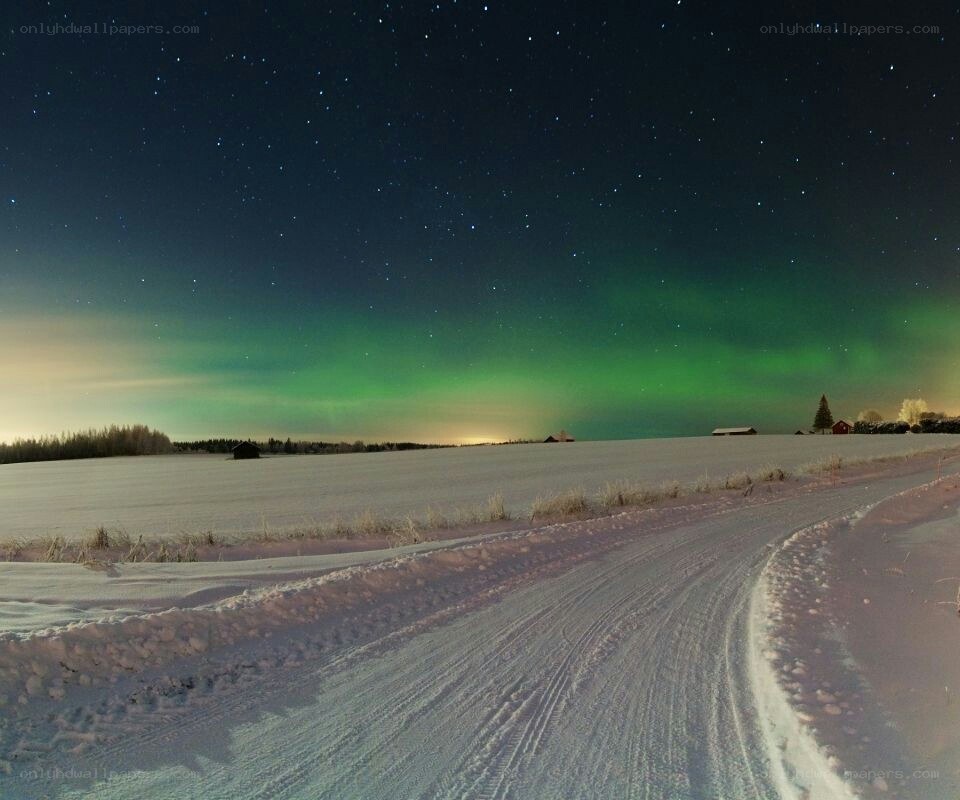 Aurora borealis over snowy landscape