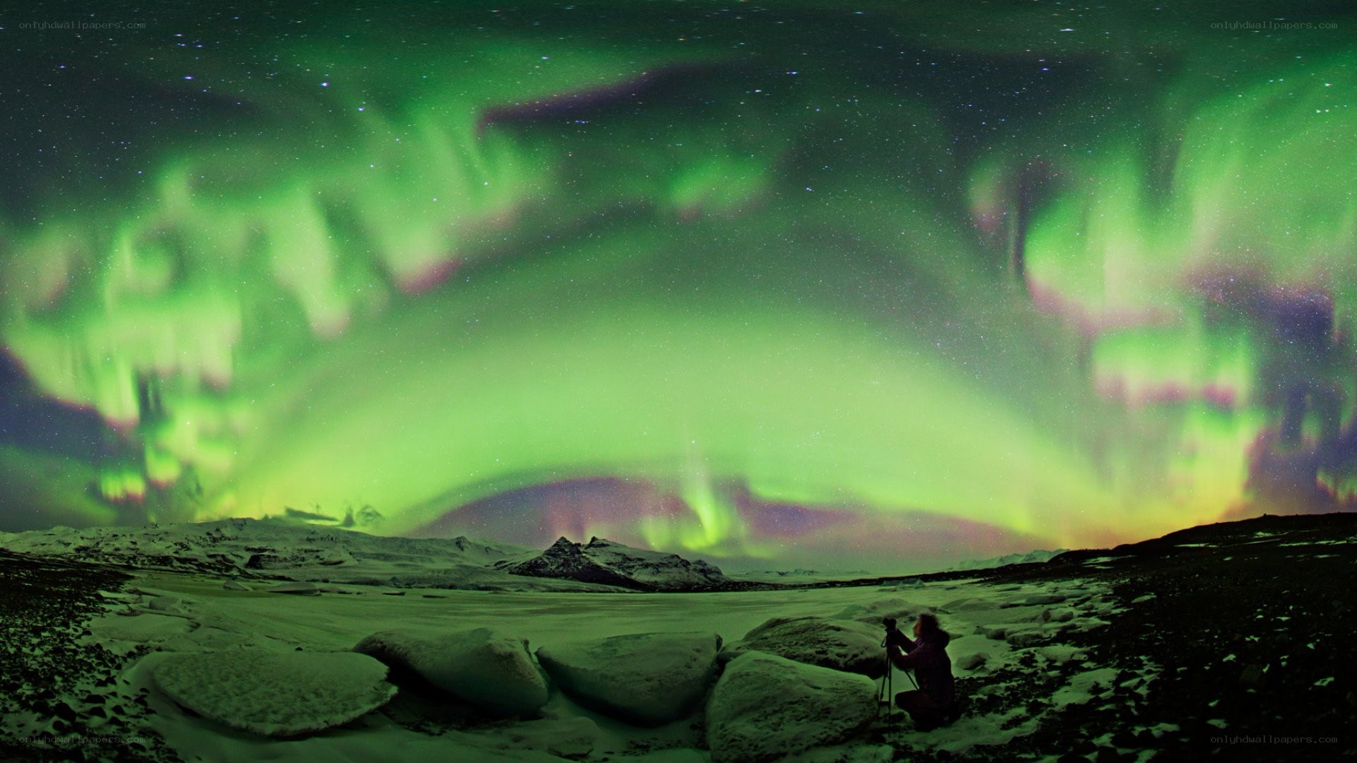Aurora borealis over snowy landscape
