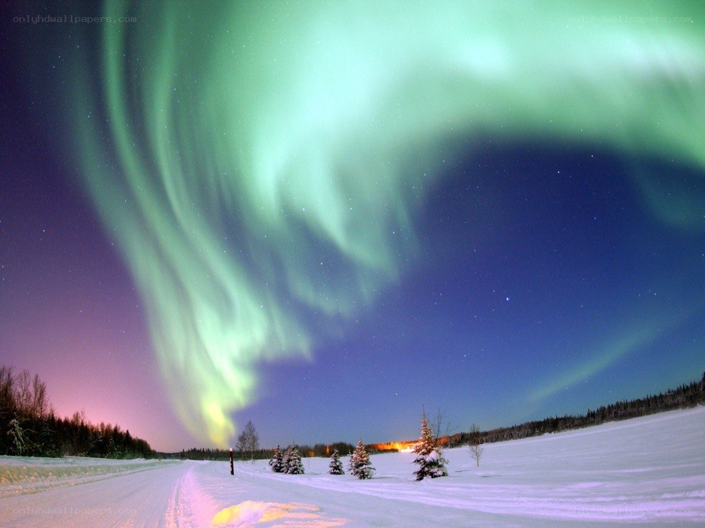 Aurora borealis over snowy landscape