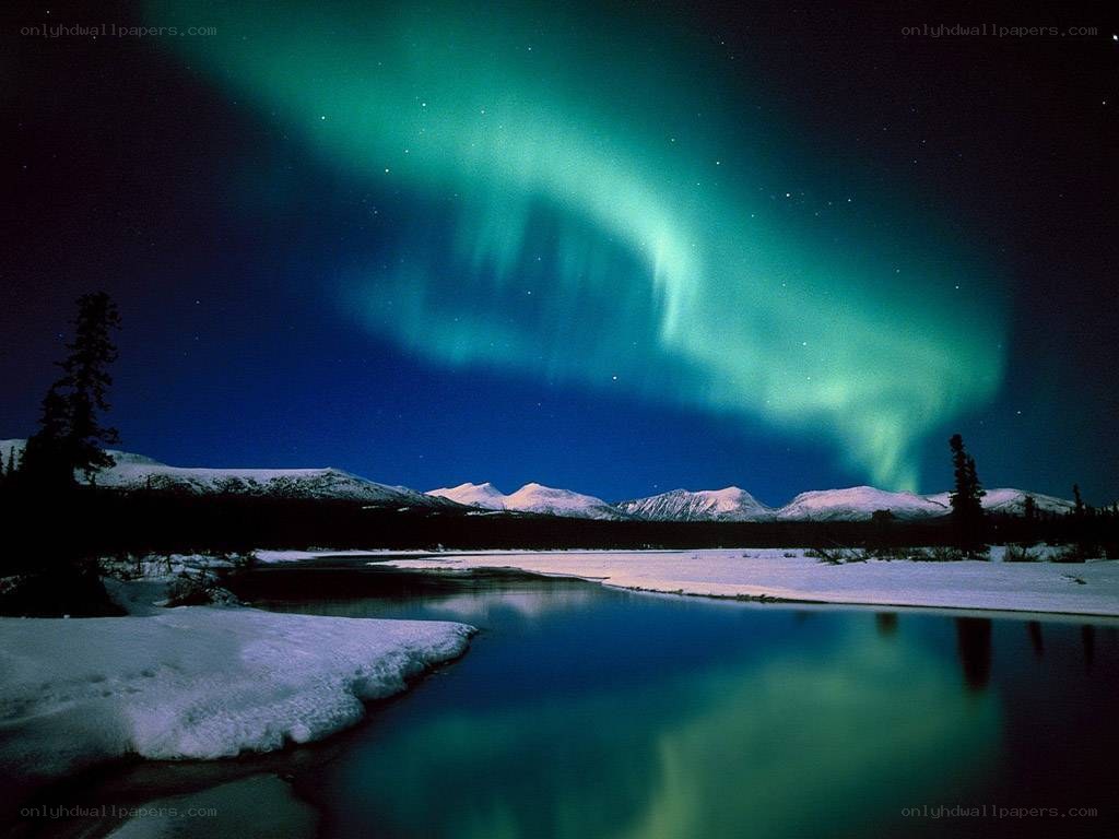 Aurora borealis over snowy landscape