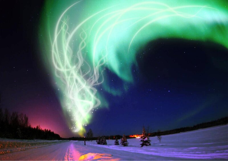 Aurora borealis over snowy landscape