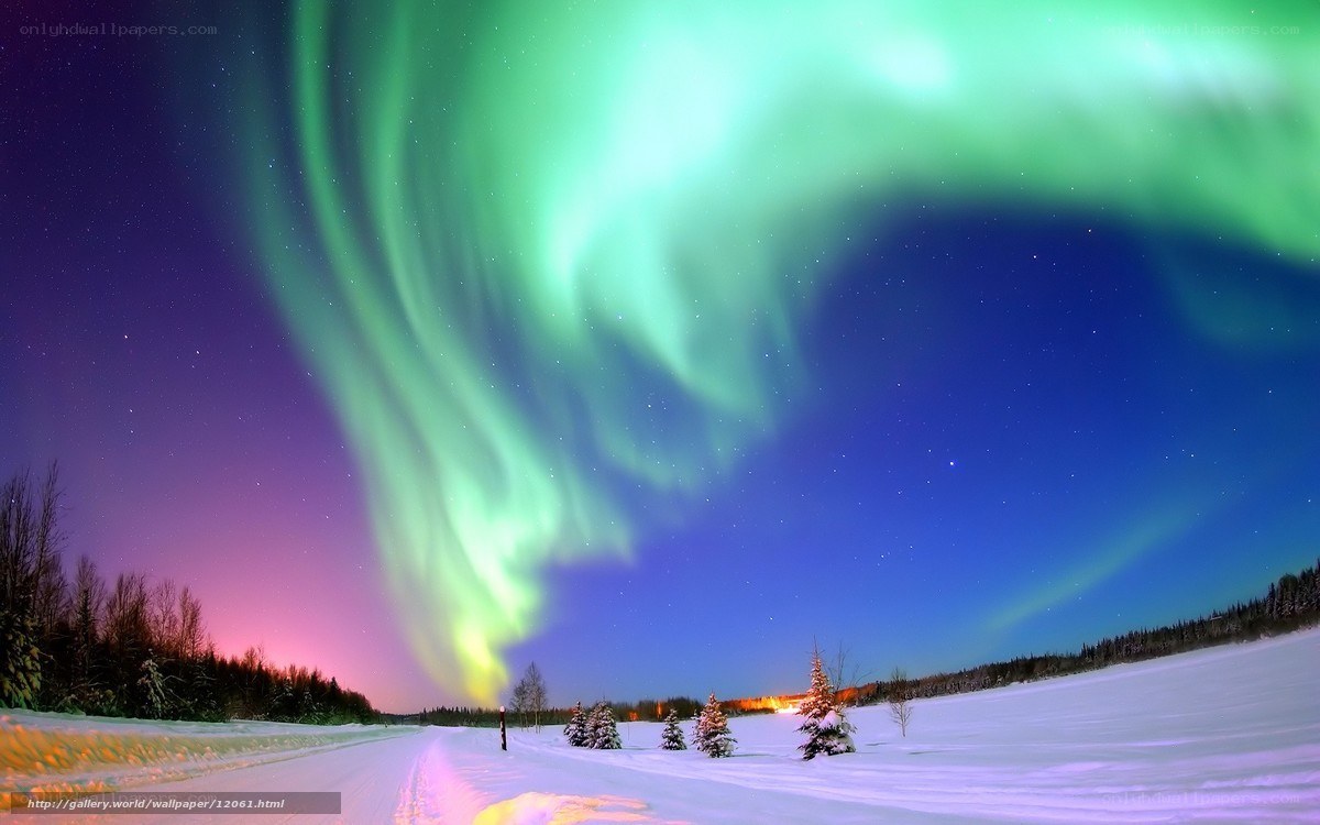 Aurora borealis over snowy landscape