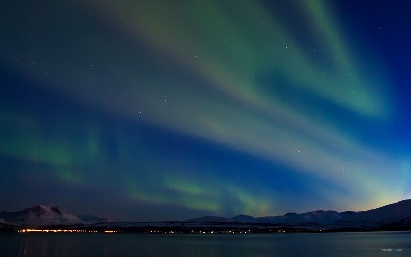 Aurora borealis over snowy mountains