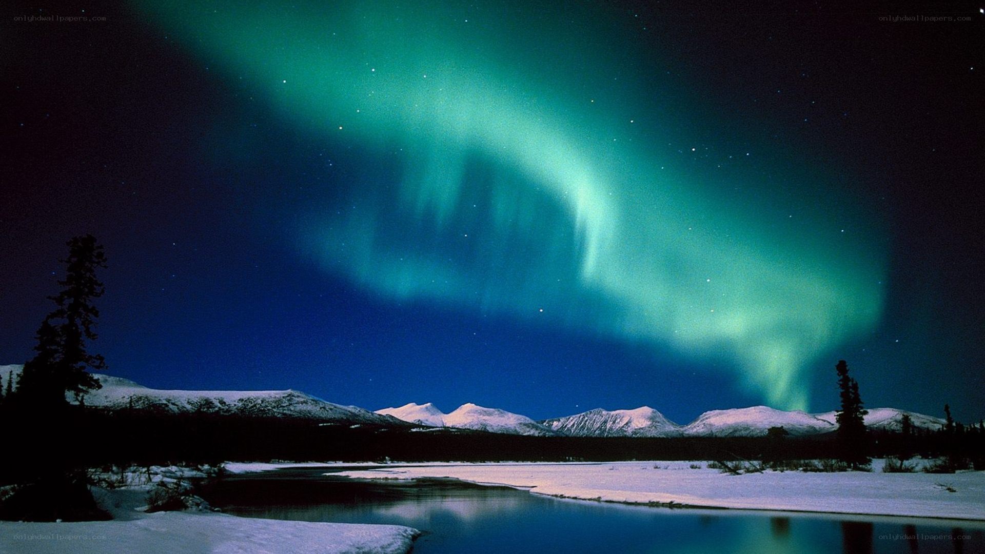 Aurora borealis over snowy mountains