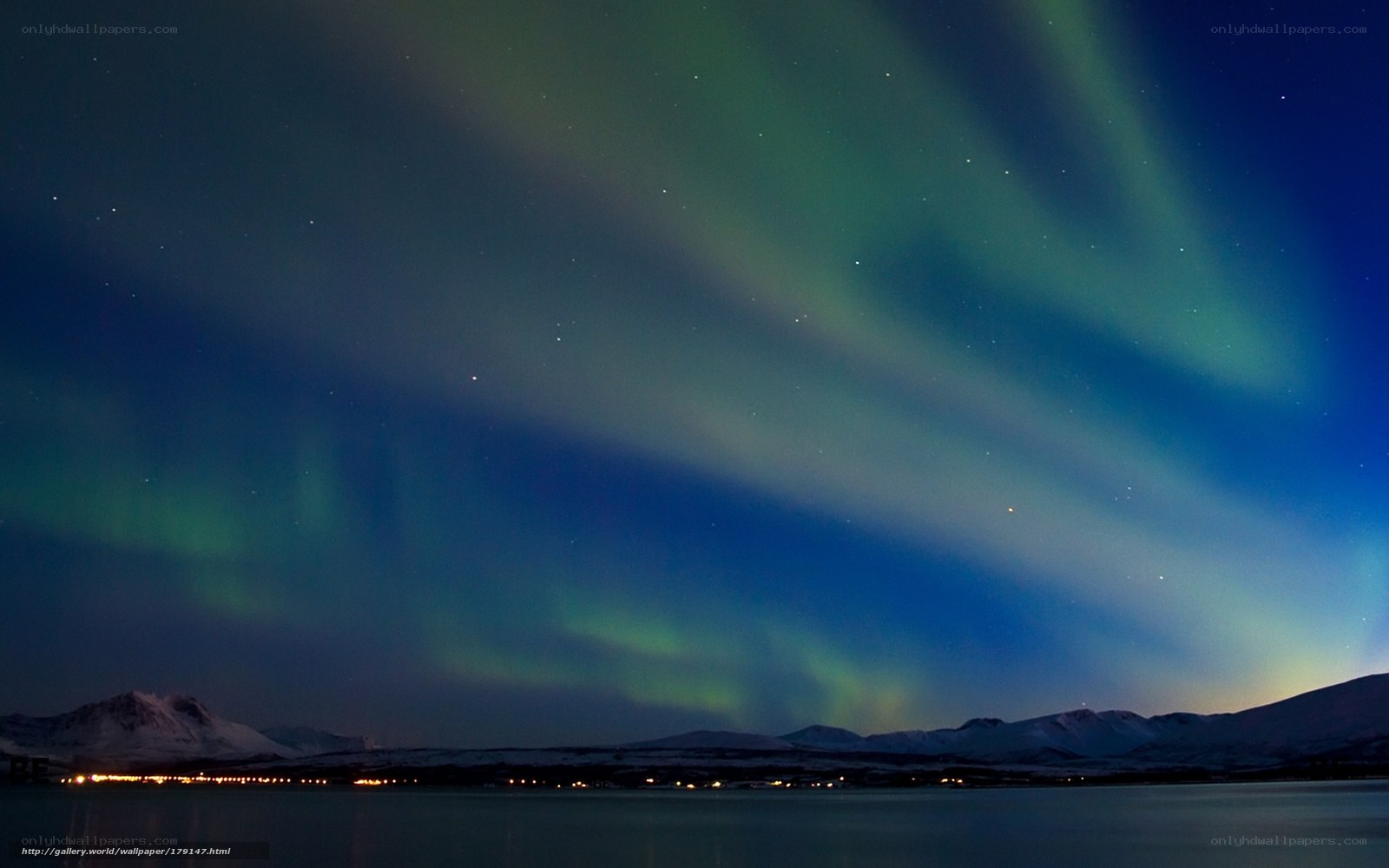 Aurora borealis over snowy mountains