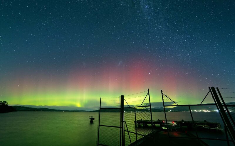 Aurora Borealis over Water — Green, Serene, Night, Photograph, Fence