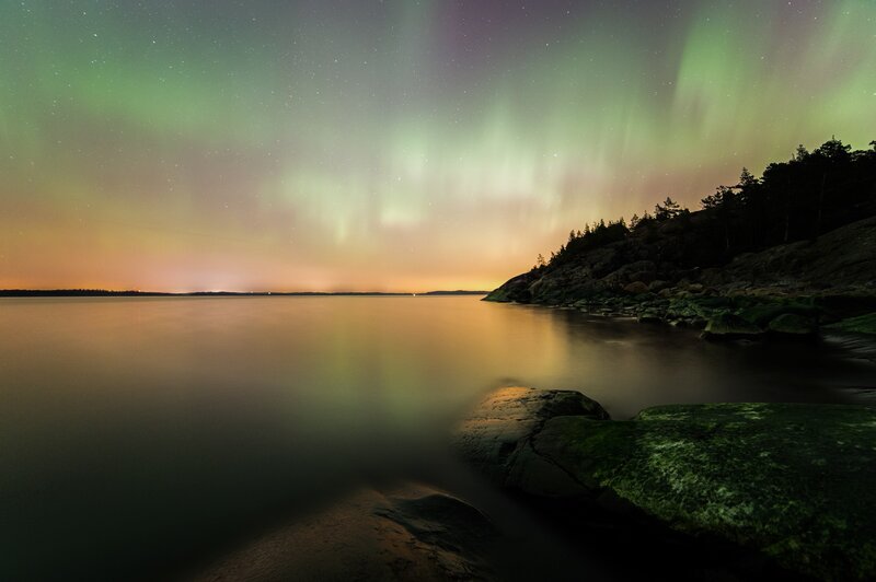 Aurora Borealis over Water — Green, Serene, Night, Photograph, Night Sky, Rocks
