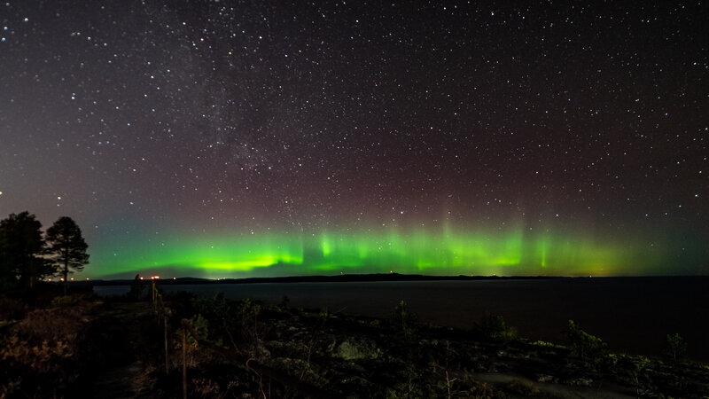Aurora Borealis over Water — Green, Serene, Night, Photograph, Stars, Trees