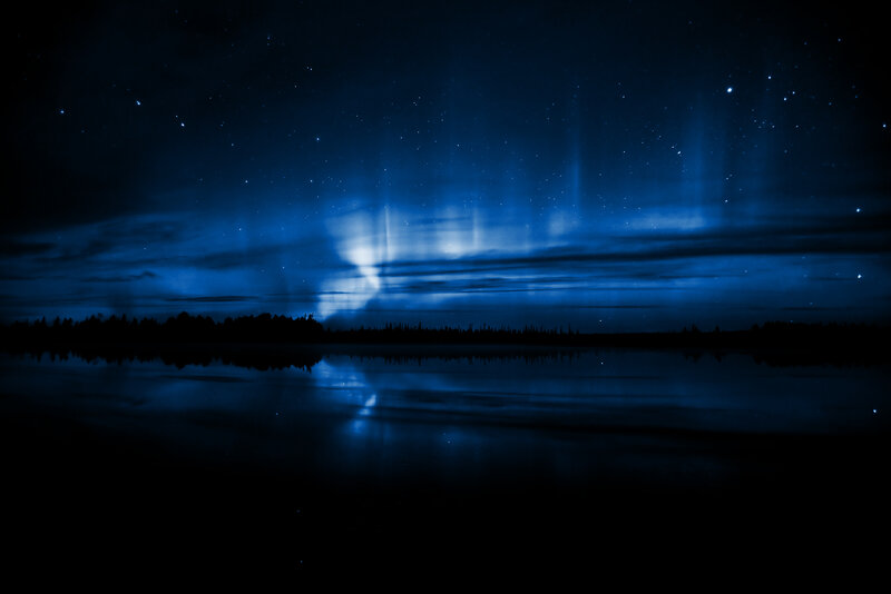 Aurora over a calm lake