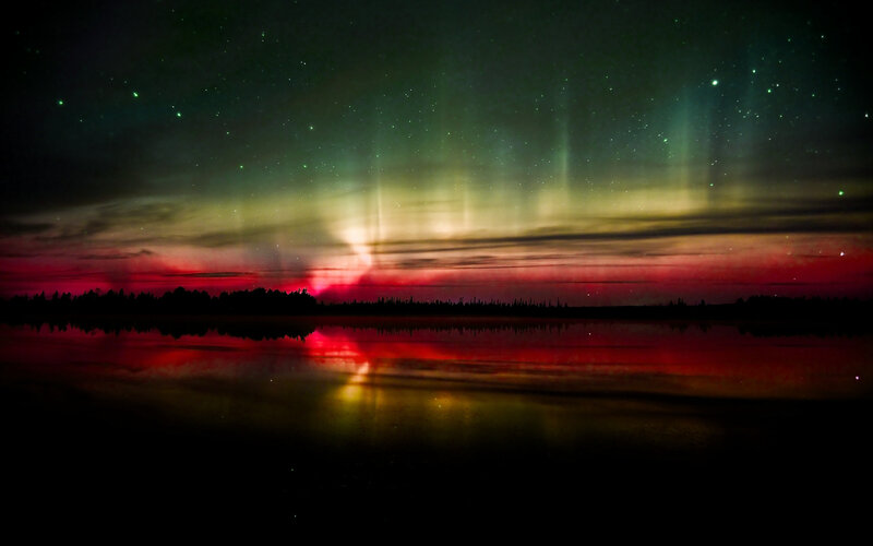 Aurora over a calm lake