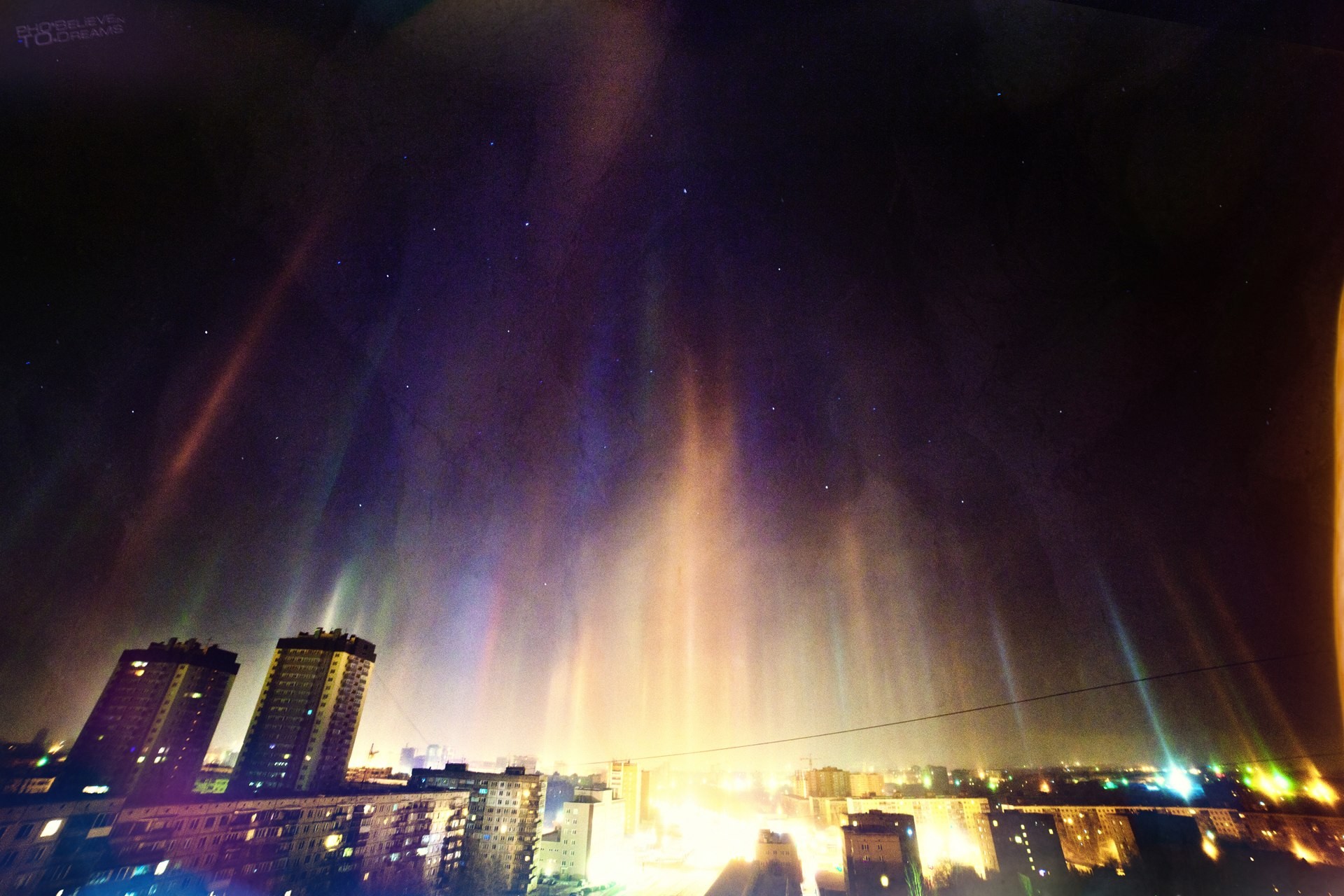 Aurora over a city at night