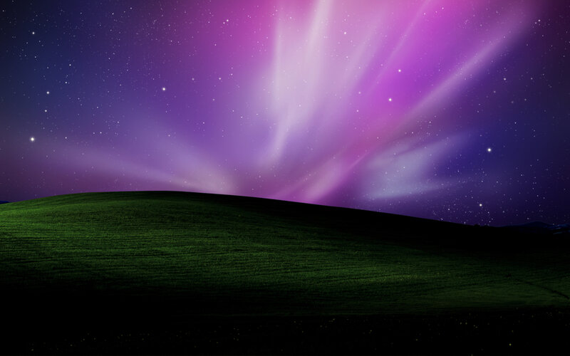 Aurora over a green hill