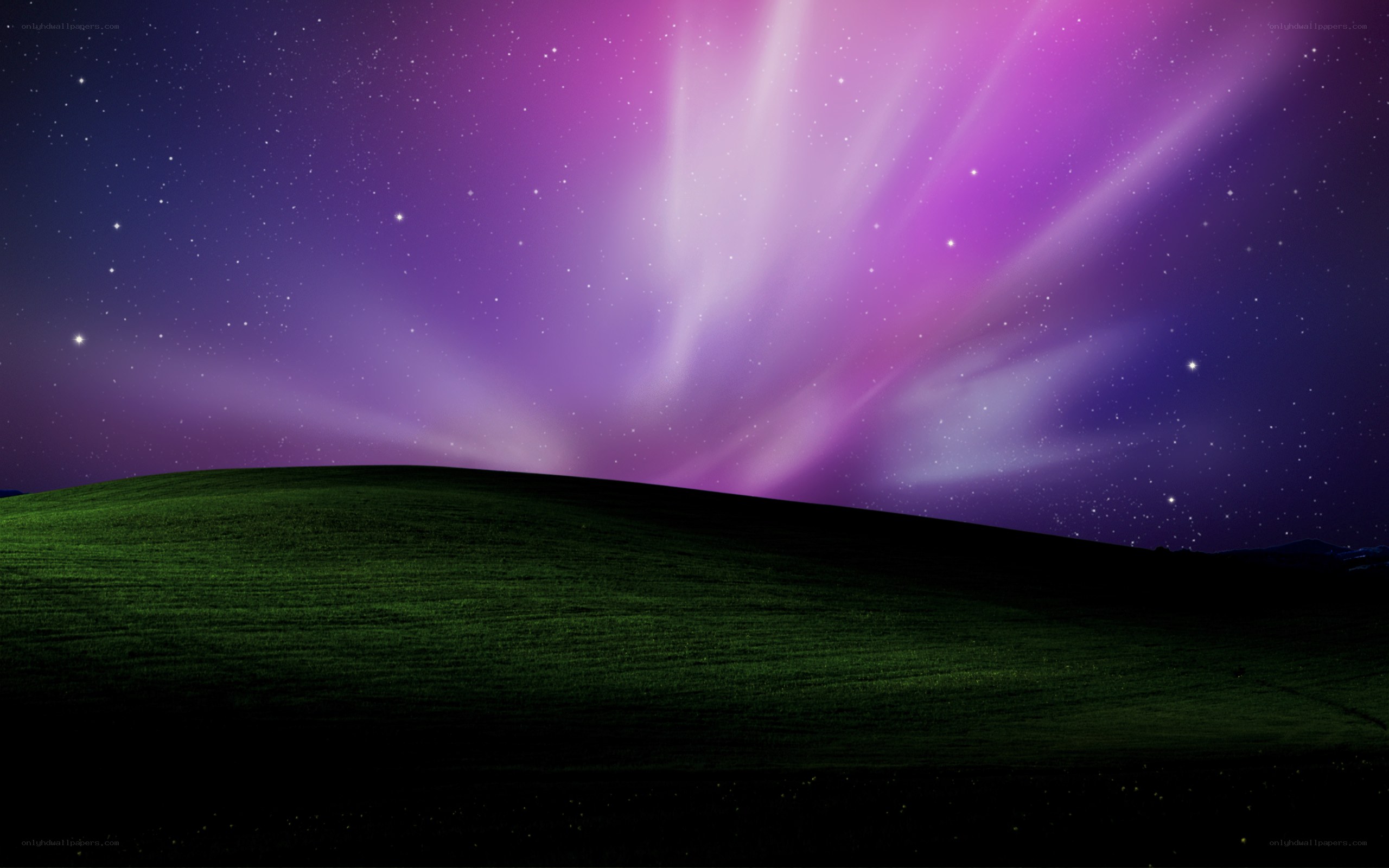 Aurora over a green hill